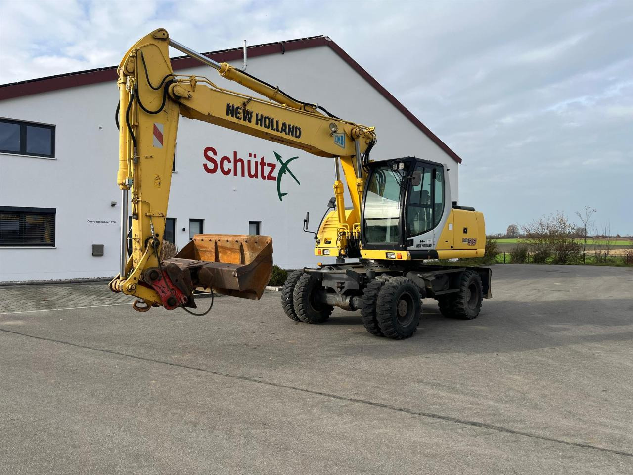 New Holland MH 5.6 inkl. Grabenlöffel, Tieflöffel - Pelle sur pneus: photos 1 New Holland MH 5.6 inkl. Grabenlöffel, Tieflöffel - Pelle sur pneus: photos 1