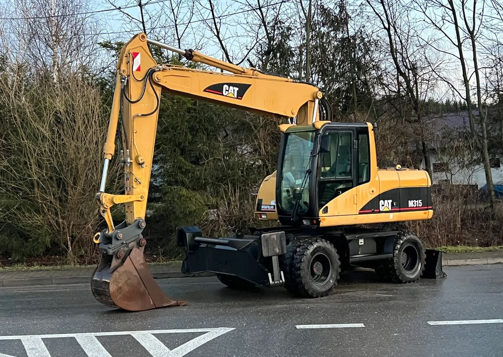 Caterpillar CAT M315C CATERPILLAR SPROWADZONY Bardzo Dobry Stan - Pelle sur pneus: photos 1 Caterpillar CAT M315C CATERPILLAR SPROWADZONY Bardzo Dobry Stan - Pelle sur pneus: photos 1