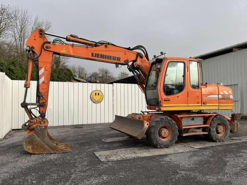 Liebherr A316 LITRONIC - Pelle sur pneus: photos 1 Liebherr A316 LITRONIC - Pelle sur pneus: photos 1